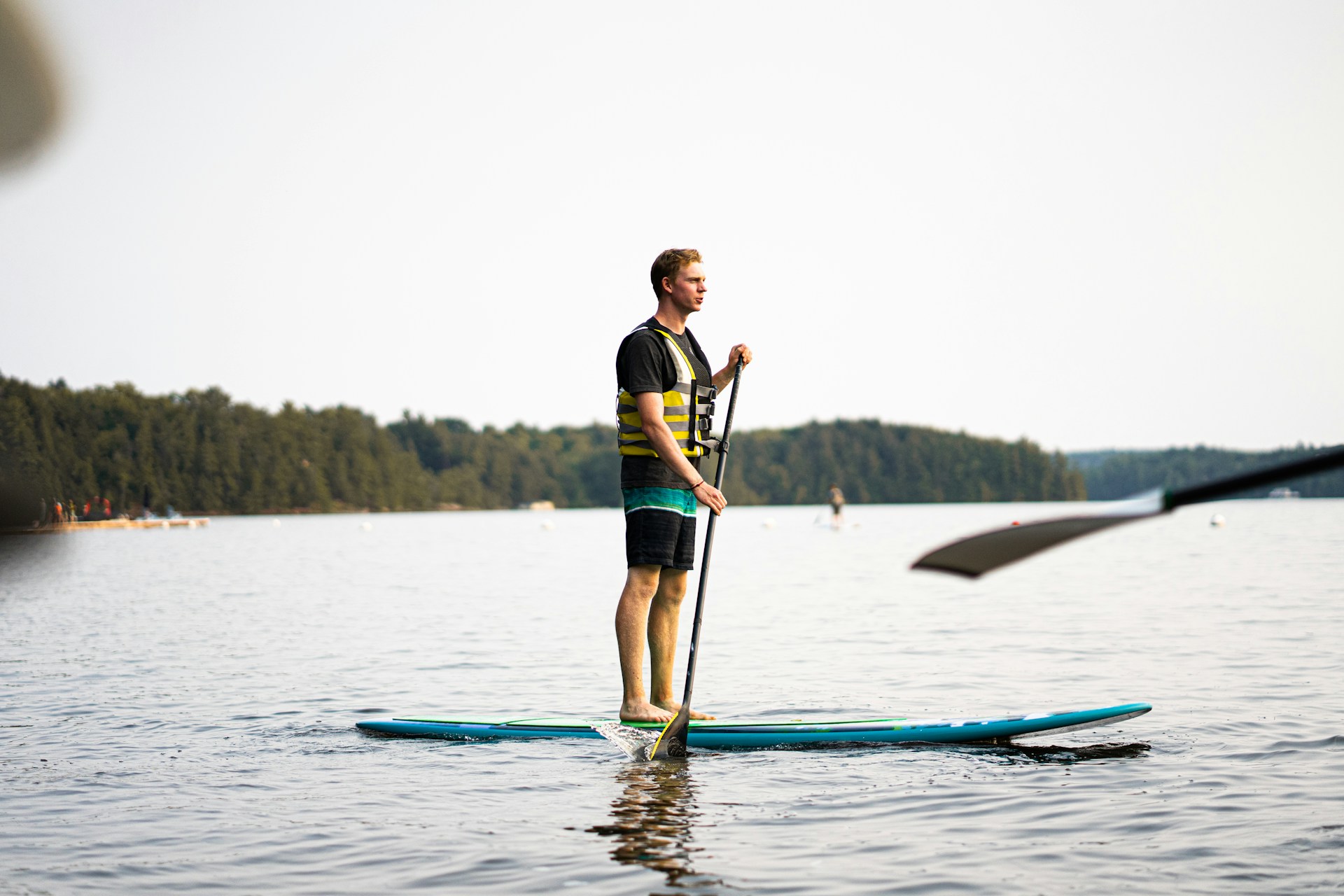 man paddleboarding | man paddleboarding