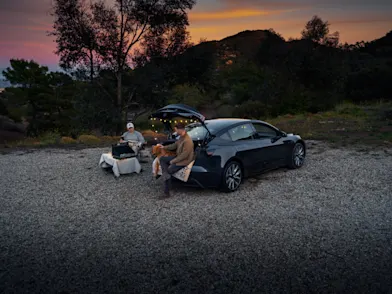 Two men camping with model 3