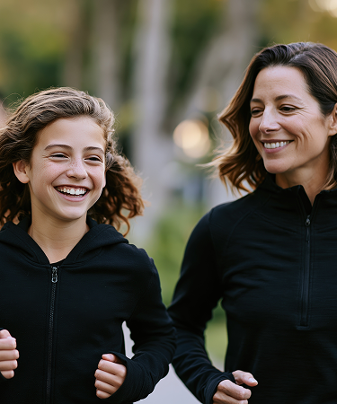 Monther and daughter Joyfully Smiling and jogging in the park