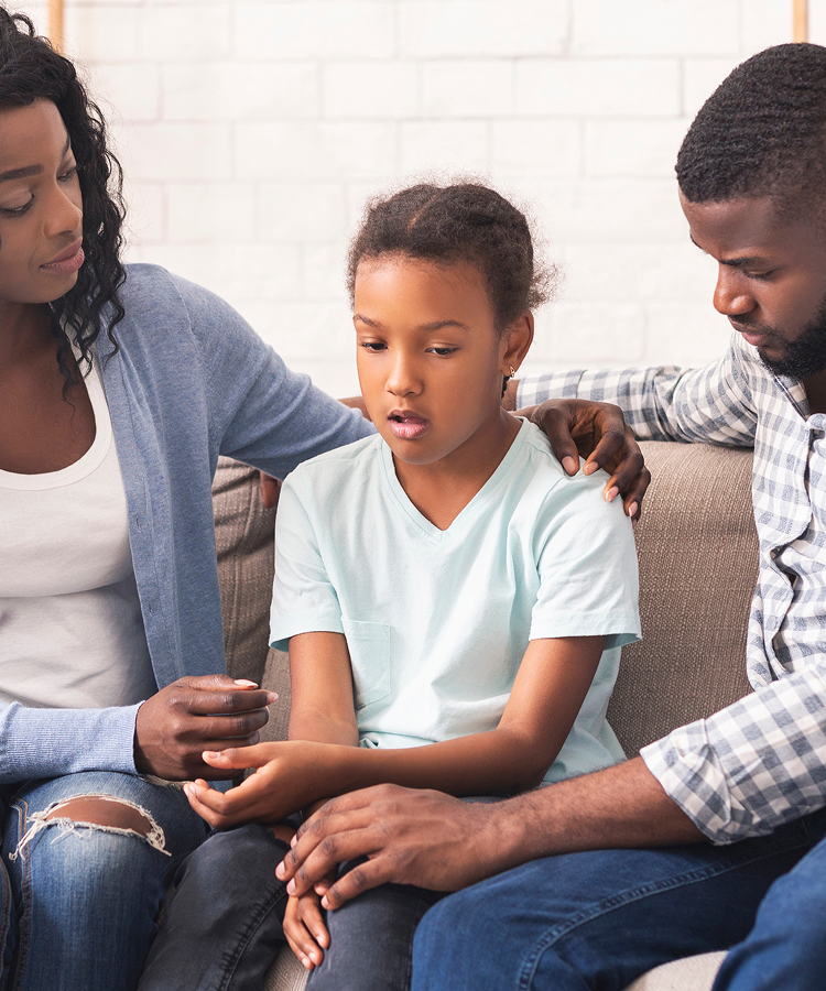Parents and their daughter discussing puberty concerns with a healthcare professional