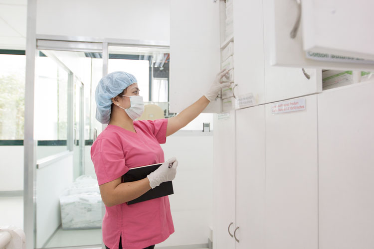 Nurse checking on medical disposables 