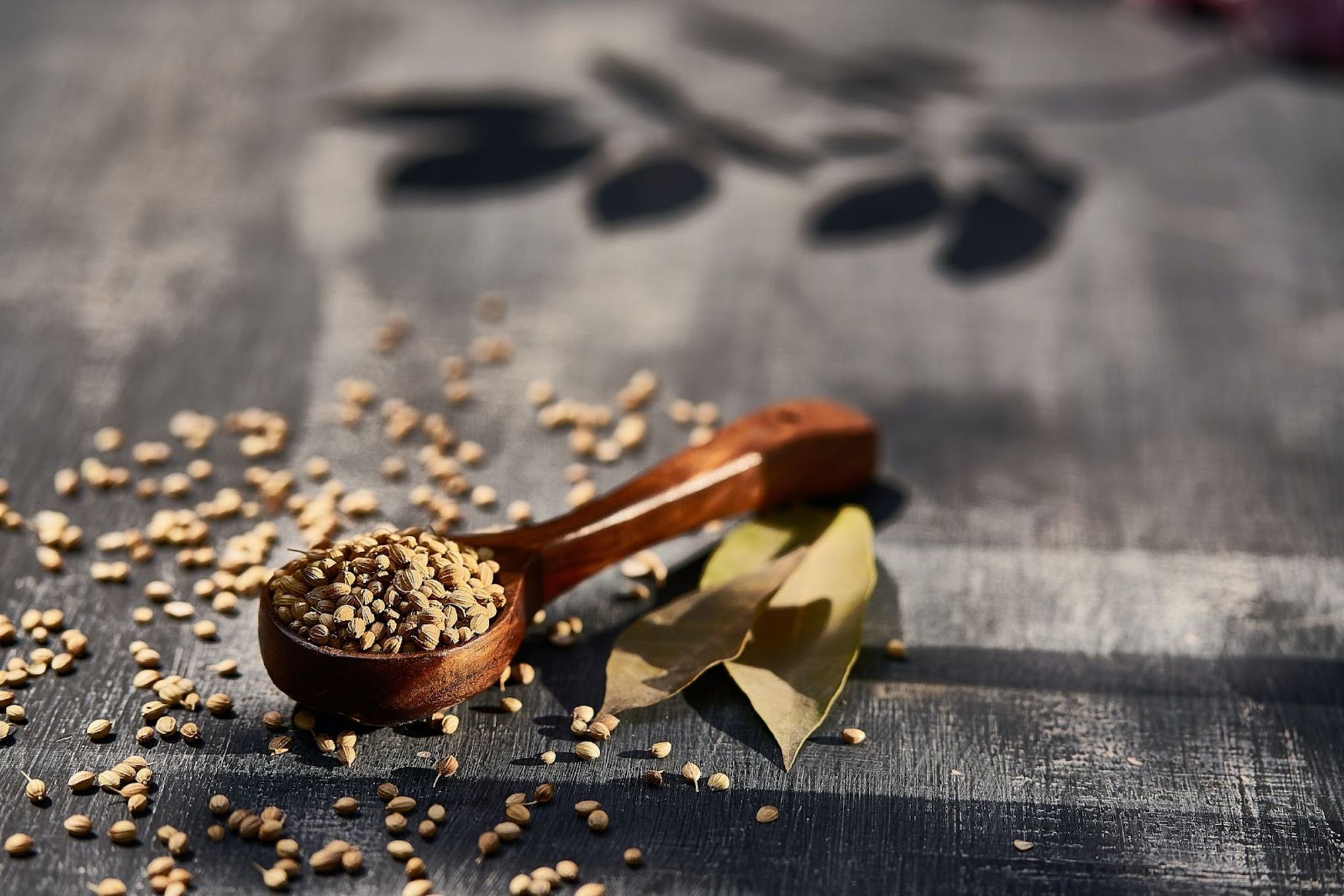 Wooden spoon with herbs on a table