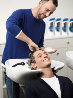 coiffeur qui lave les cheveux d'un homme