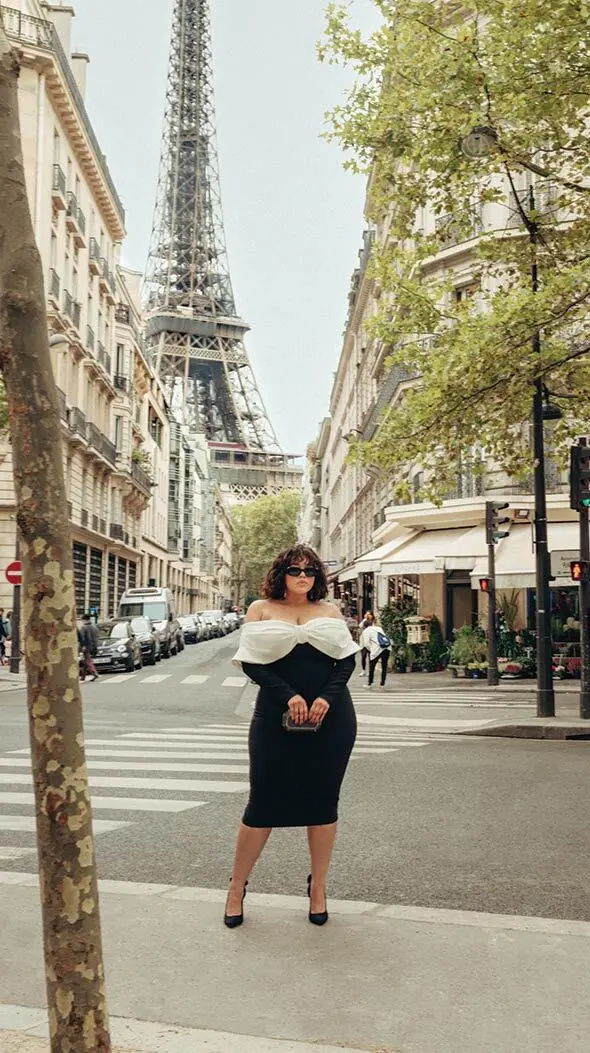Gabi Fresh wearing a plus size dress in front of Eiffel Tower