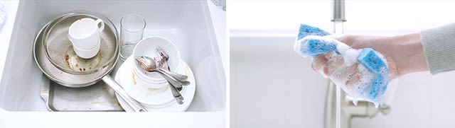 Pile of dirty dishes in sink and hand squeezing soapy sponge under faucet