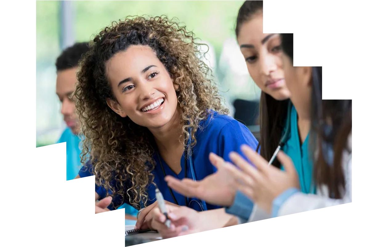 Young female nursing student talking to fellow students in a classroom