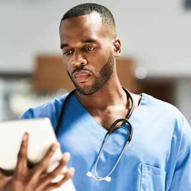 Male health worker using tablet