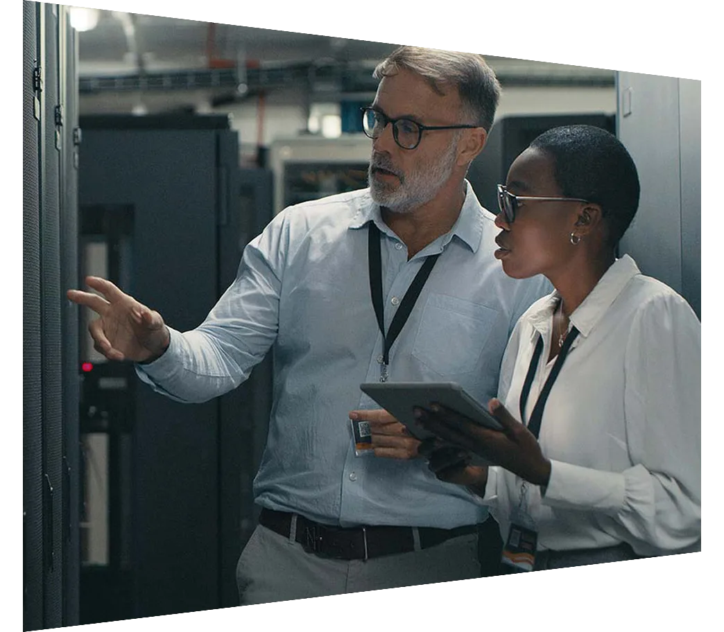 Colleagues using a digital tablet while working in a data centre