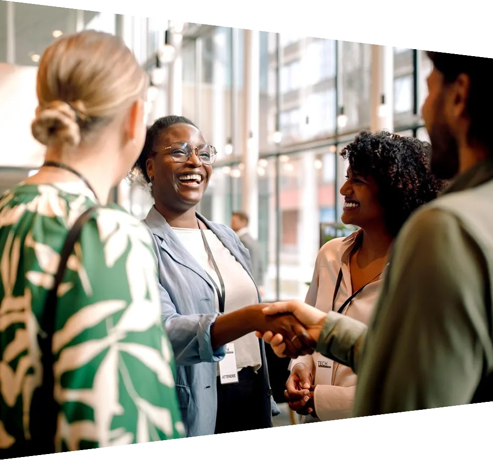 Happy business professionals laughing while interacting with each other during seminar at convention center