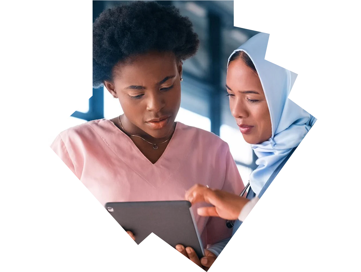Two female medical students looking at a digital tablet together