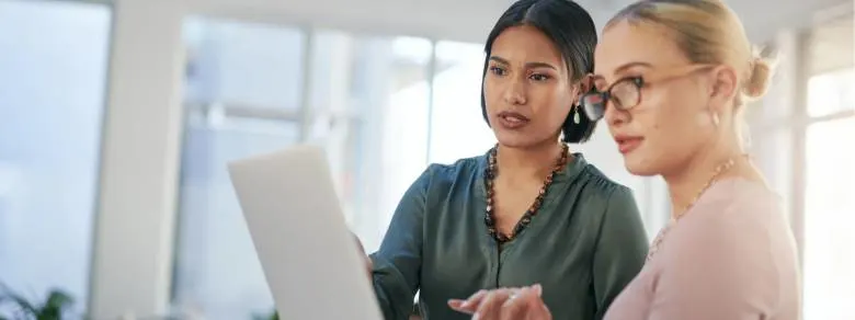 two_young_businesswomen_using_a_laptop