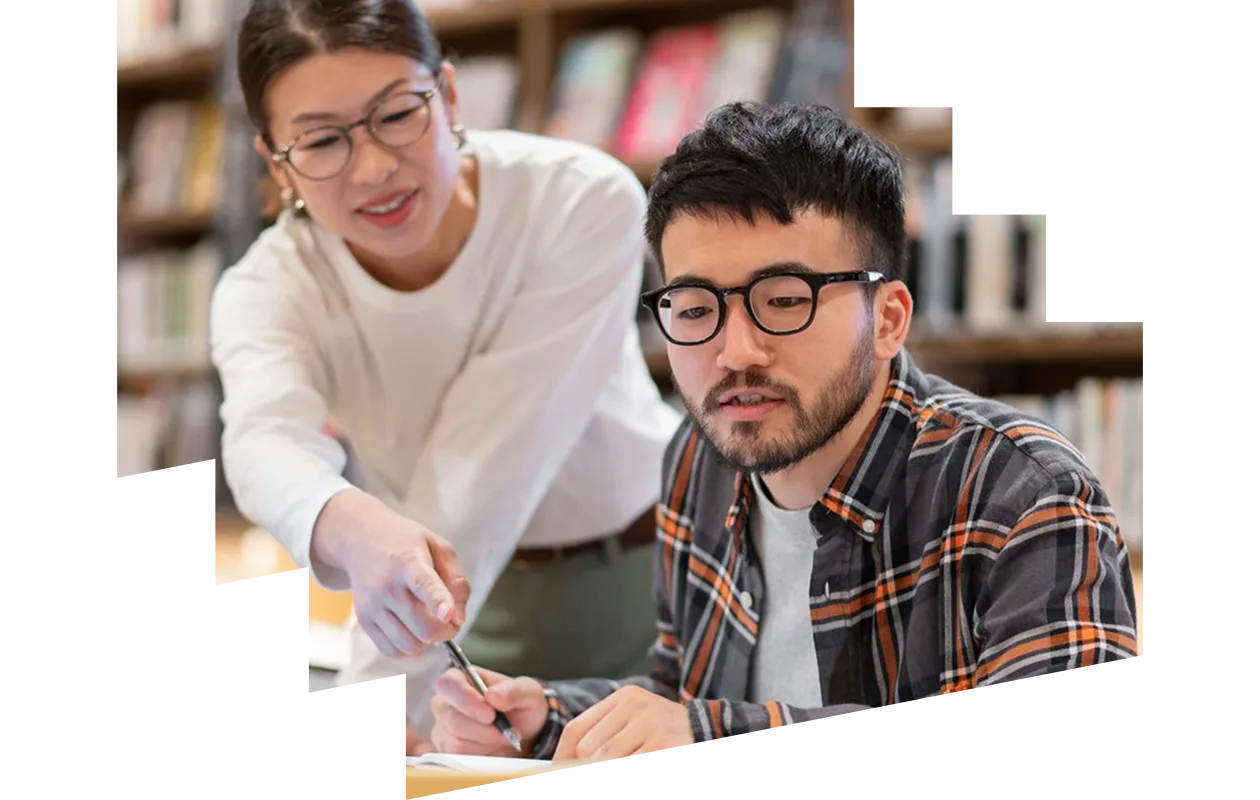 Professor talking to a student in a library