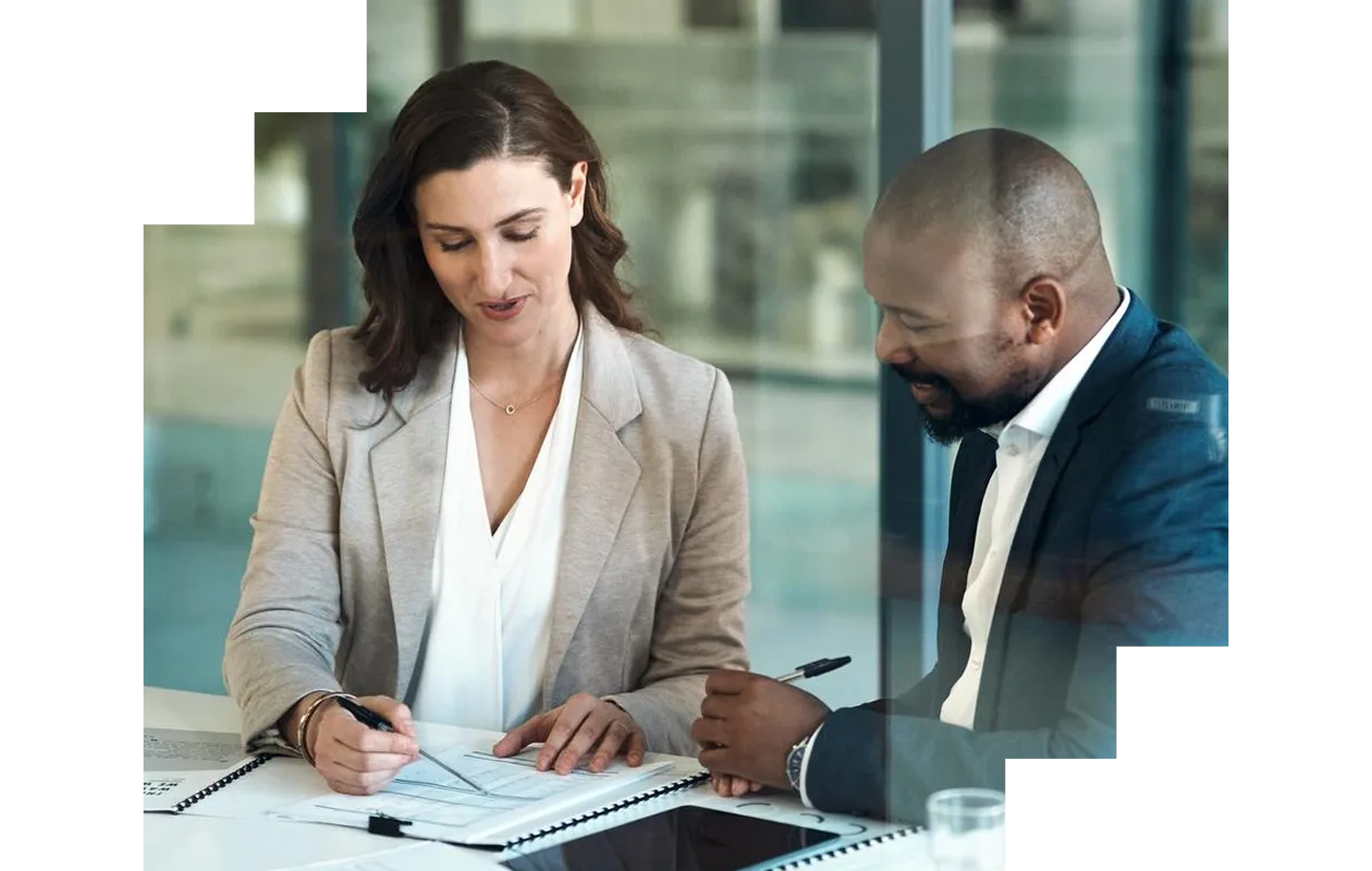 Two business colleagues discussing documents at a table in the office