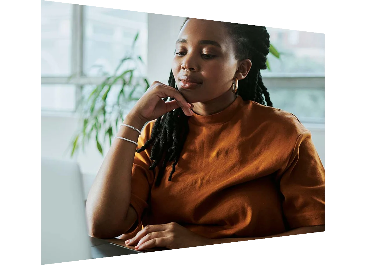 African American female programmer working on computer coding in the office