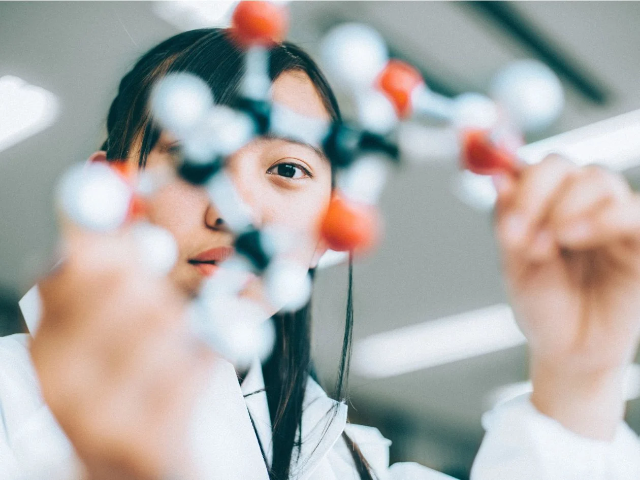 A chemists looking at a molecular model kit