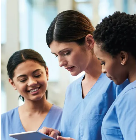 Three nurses discussing content of ipad