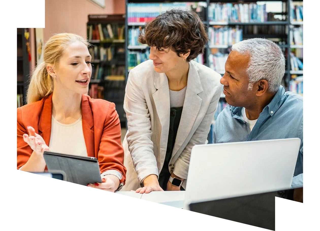 Three people sitting around a table in conversation.