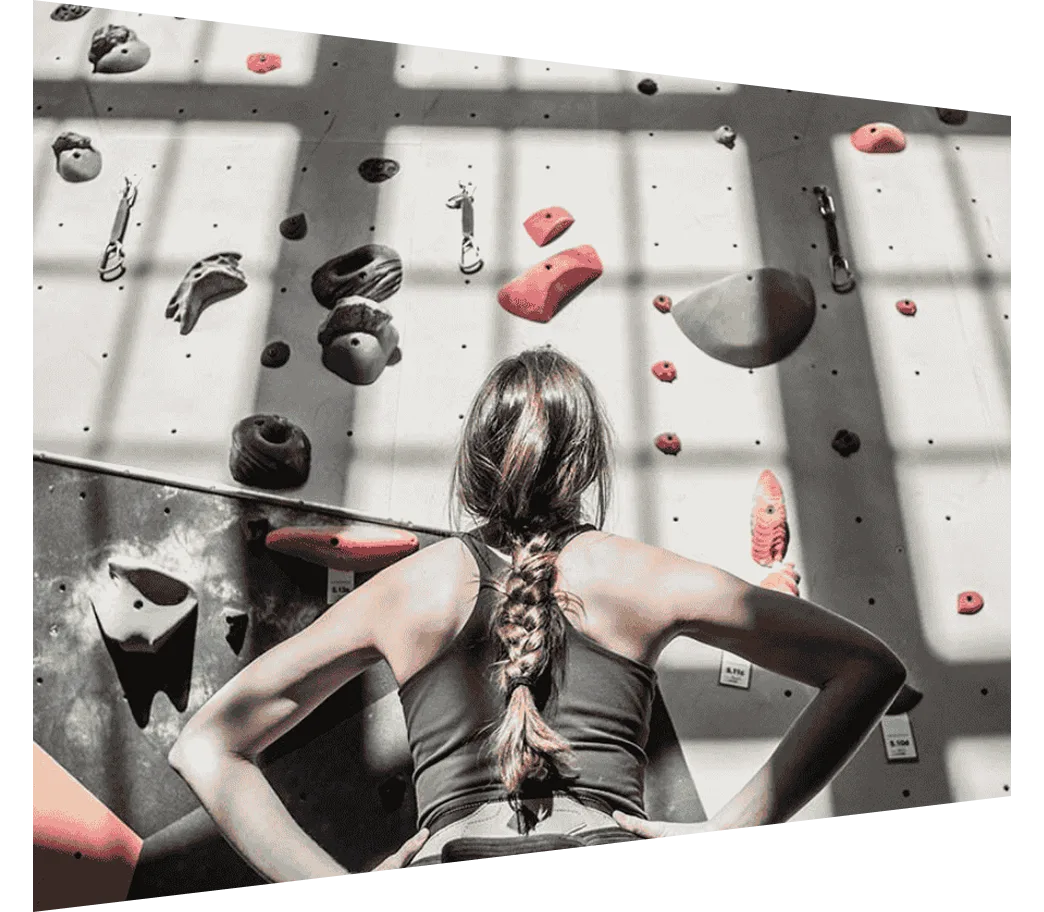 woman looking at climbing wall
