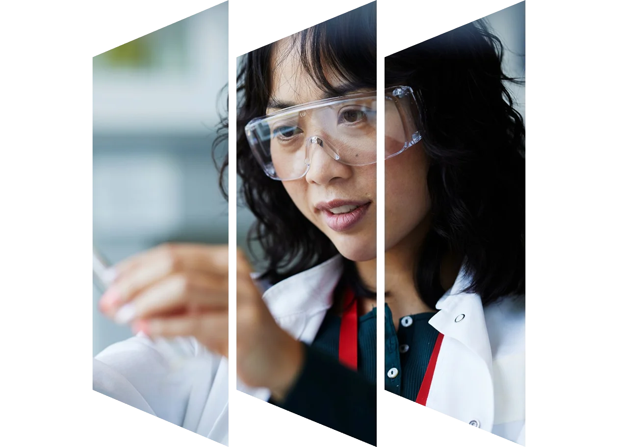 Female scientist looking at chemistry flask