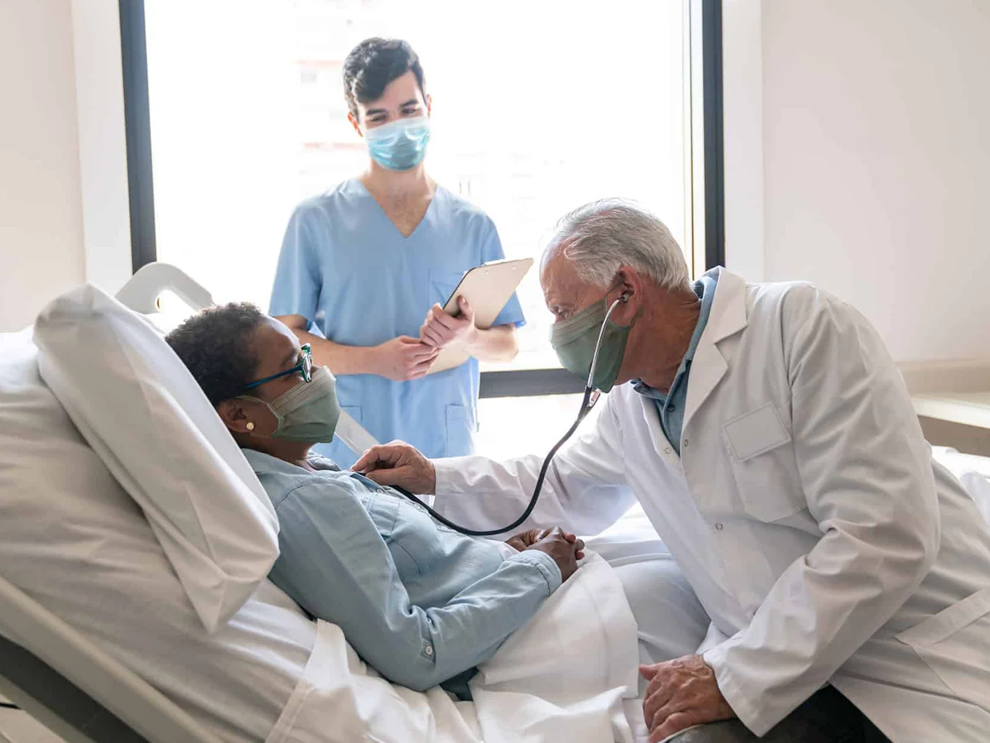 Male doctor checking female patient