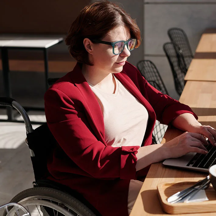 Woman in wheelchair working on laptop
