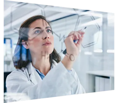 Shot of a scientist solving equations on a glass screen in a laboratory