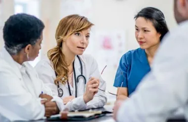 Female doctor conferring with colleagues