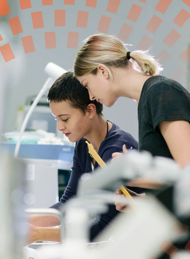 Two young female technicians working in a hospital workshop