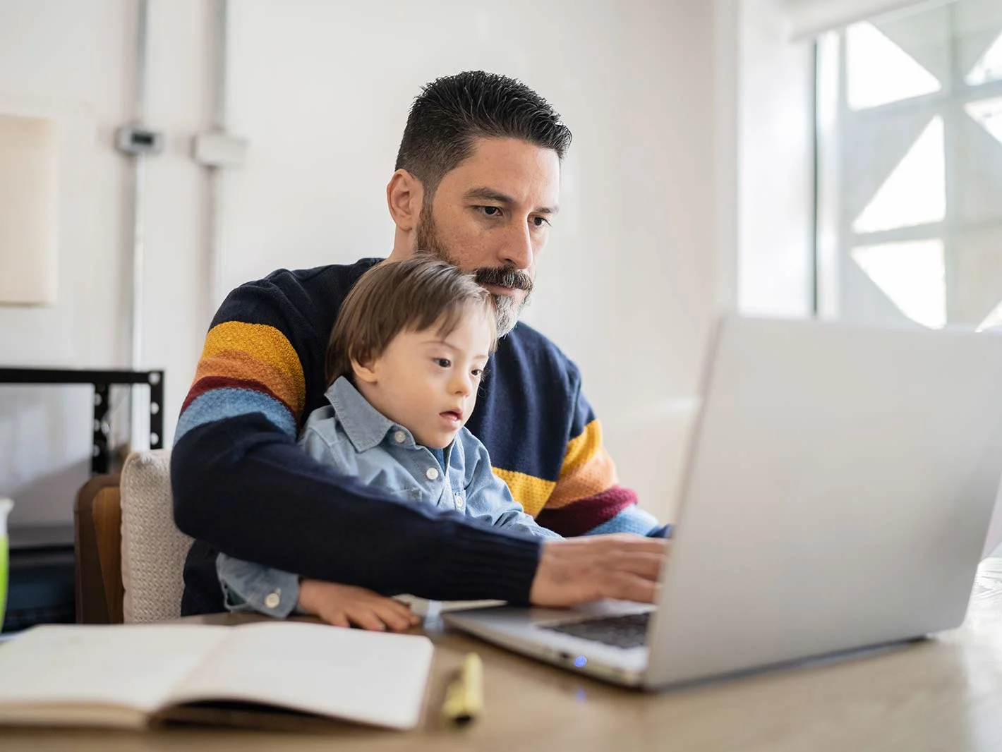 Man working at home with son