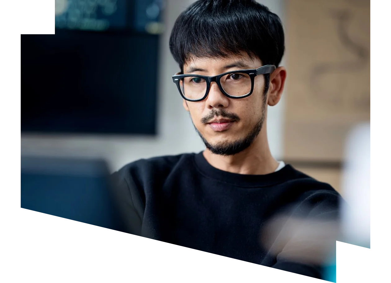 A male software developer using a computer to code 