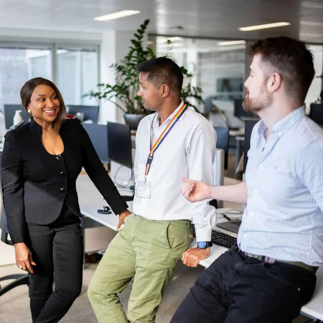 Sales, marketing and customer success team conversing in an Elsevier office