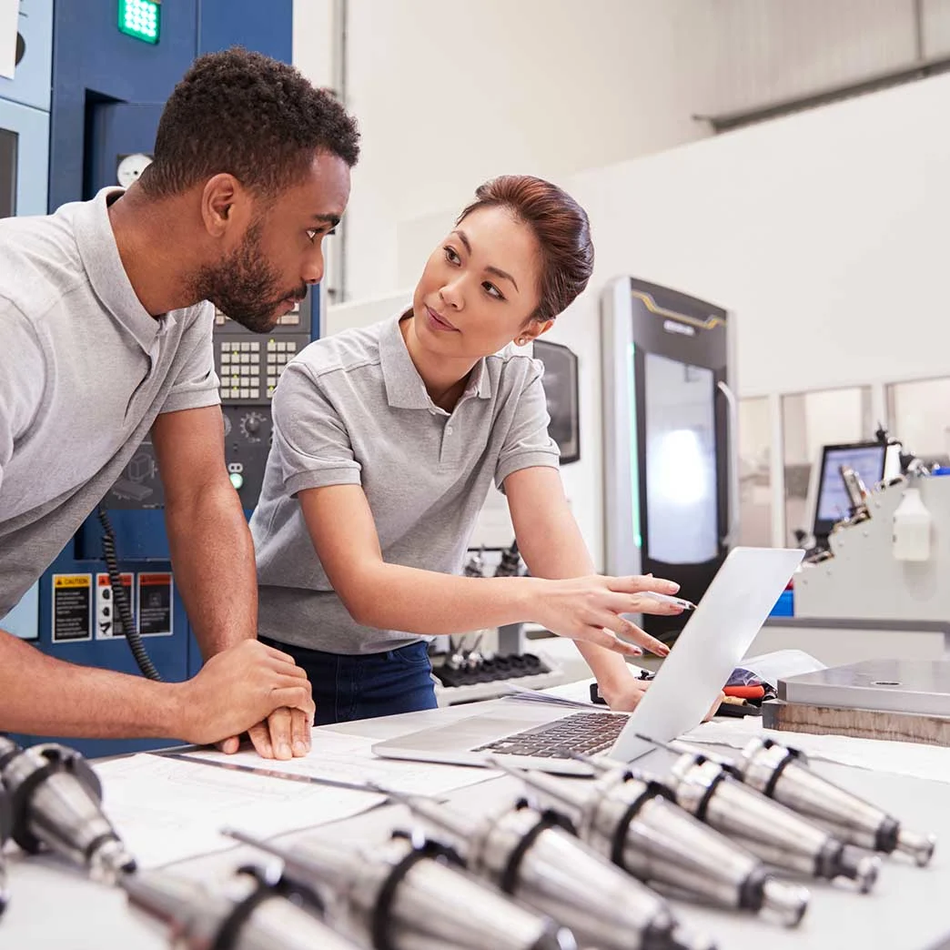 Man and woman engineers working with laptop