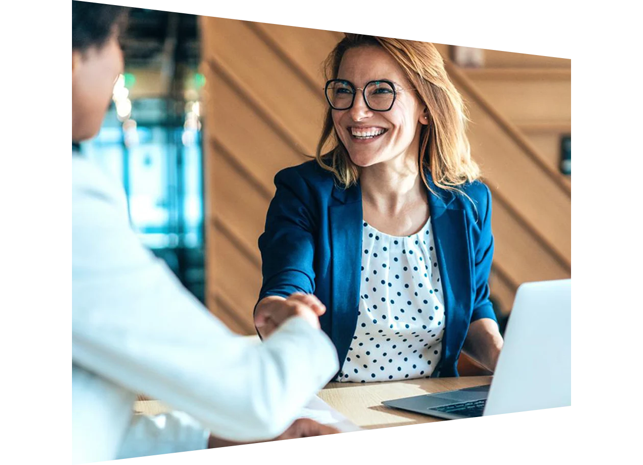 Two smiling businesswomen shaking hands