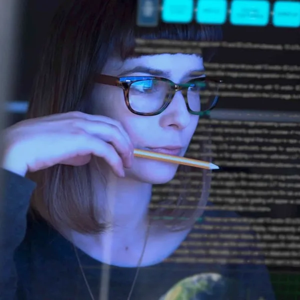 Woman studying seen through a computer screen