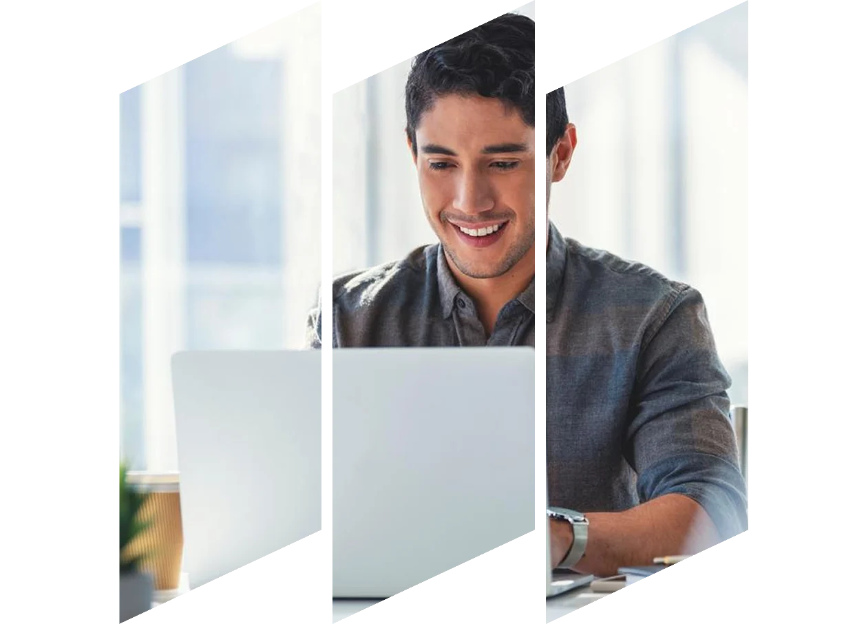 A man with glasses smiling brightly.