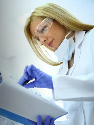 Woman in lab coat doing medical test