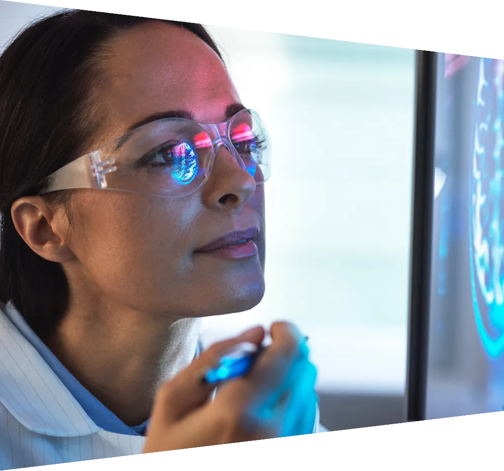 Scientist in glasses looking at screen with medical data