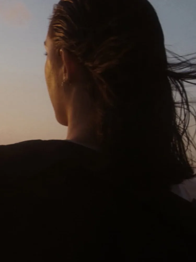 Woman at beach looking into the distance