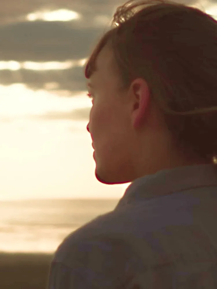 Woman at beach looking into the distance