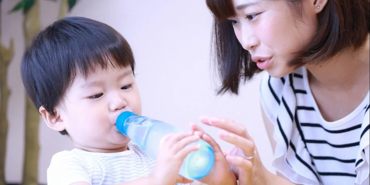 A child drinking bottled water
