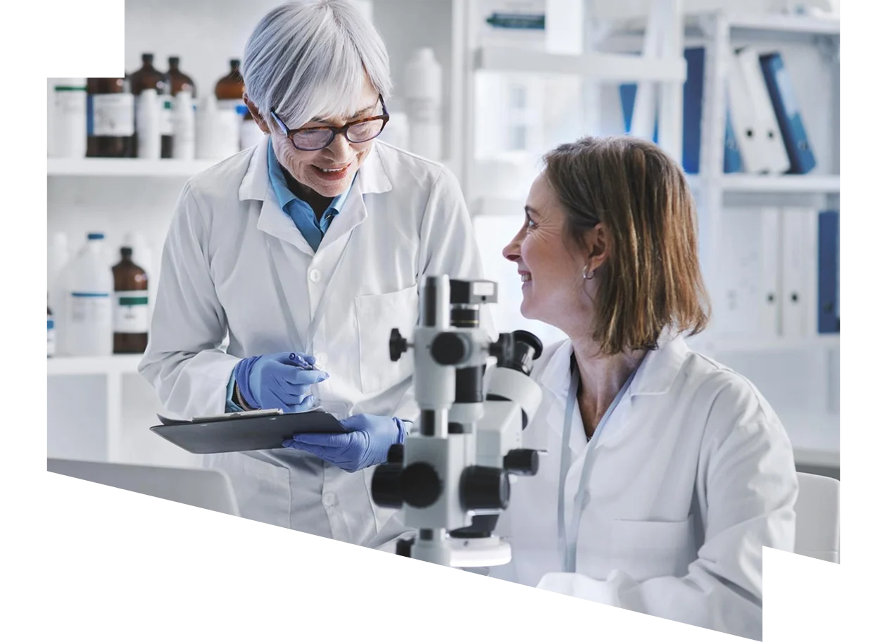 Two mature scientists working together in a lab