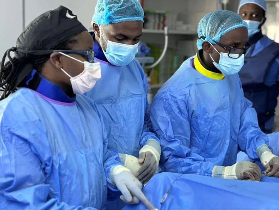 Dr Judy Gichoya (left) supports the interventional radiology medical team in Rwanda, led by Dr Ivan Rukundo. She shared this image with permission in her presentation as one of three panelists on the Lancet Webinar AI and Health Equity in Cancer.