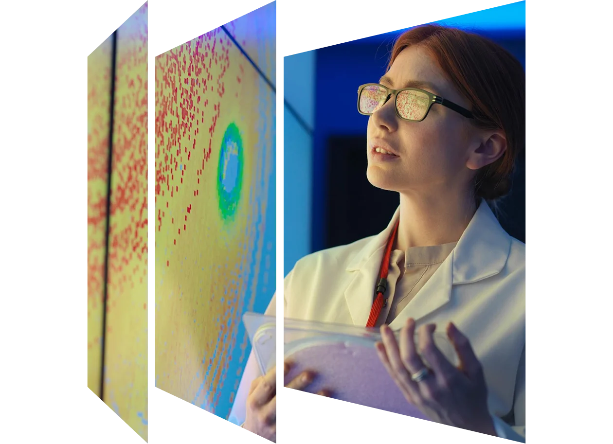 Female scientist with silicon wafer studying graphical display of wafer on a screen