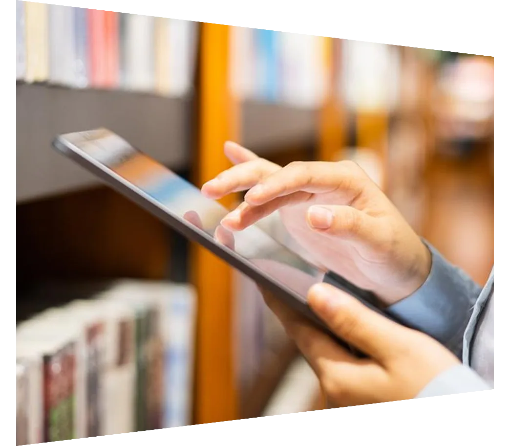 Woman looking at tablet in library