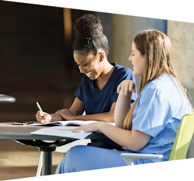 Young adult female nursing students enjoying studying together