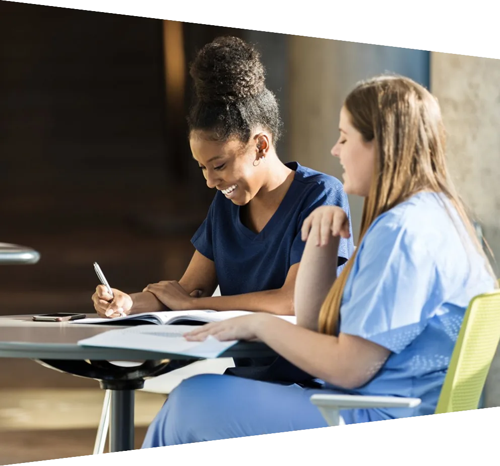 Young adult female nursing students enjoying studying together