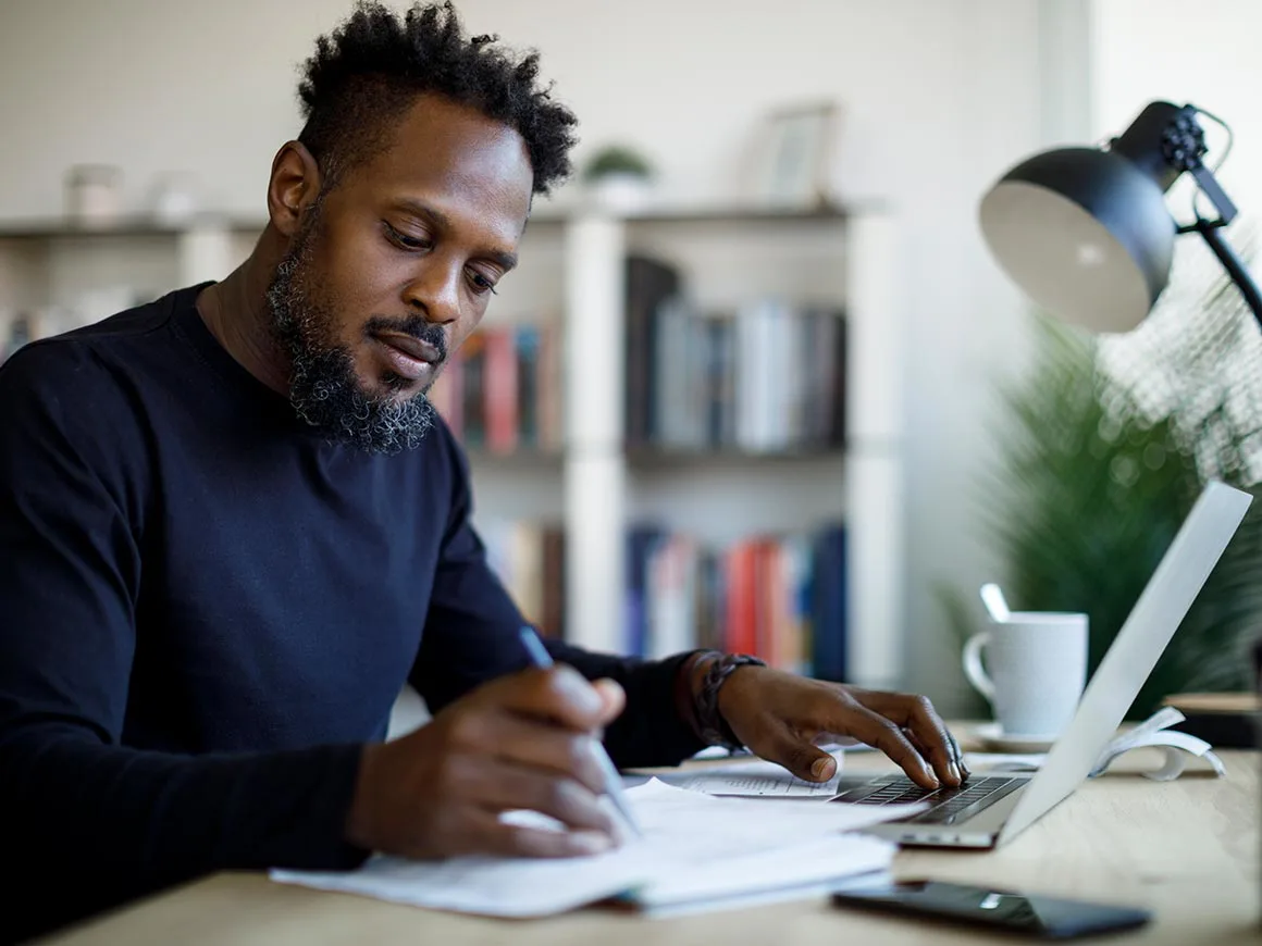 Man writing at desk