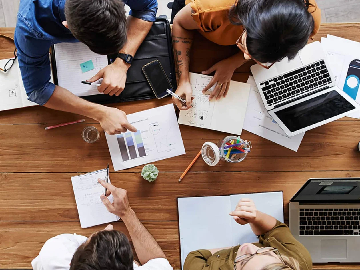 Overhead view of group of students working together round a table