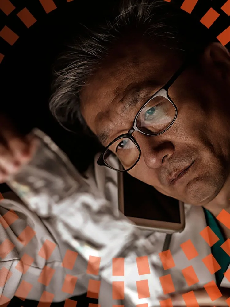 Middle aged doctor talking on smartphone with medicine