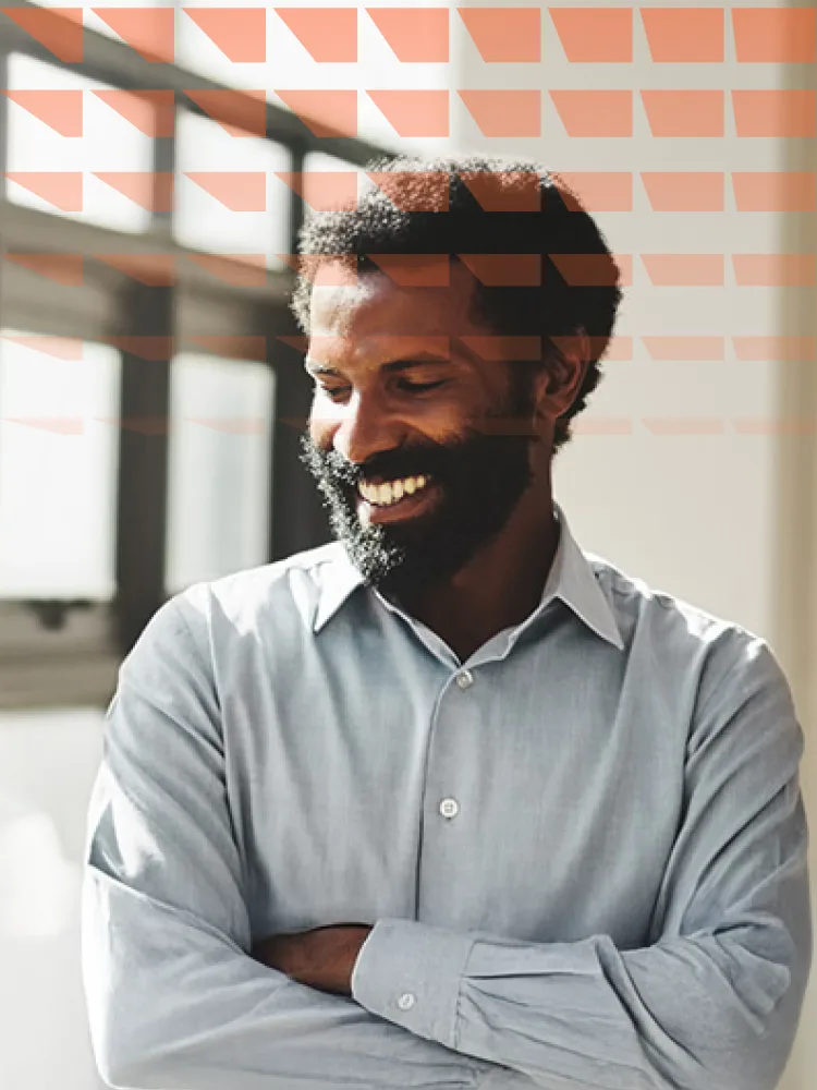 Smiling man standing next to window